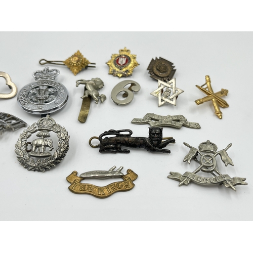 2261 - A collection of military and police cap badges to include Royal Fiji Police, Royal Kent West, Cheshi... 