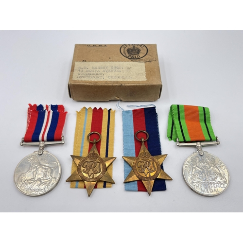 2280 - Four WWII medals, The Defence, War, The 1939-1945 Star and The Africa Star with documents and box