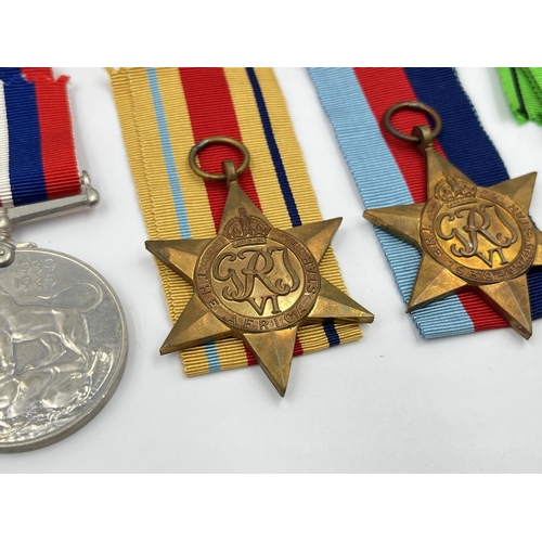 2280 - Four WWII medals, The Defence, War, The 1939-1945 Star and The Africa Star with documents and box