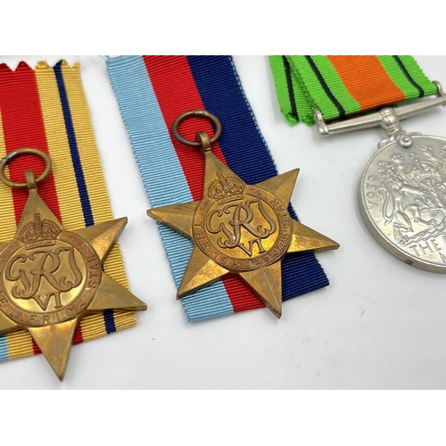 2280 - Four WWII medals, The Defence, War, The 1939-1945 Star and The Africa Star with documents and box