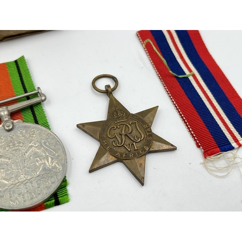 2290 - Four WWII medals, The Defence, The 1939-1945 Star, The Italy Star and The Africa Star with document ... 