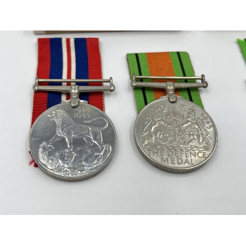 2291 - Four WWII medals, two Defence and two War with two boxes and documents