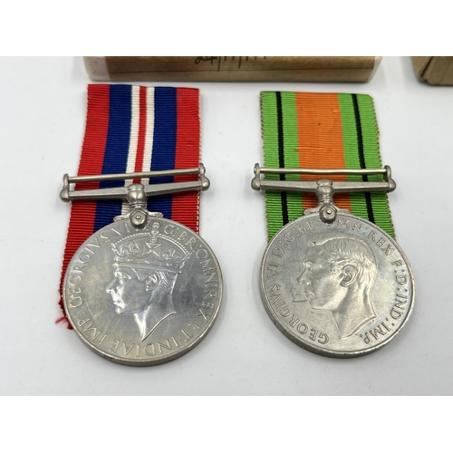 2291 - Four WWII medals, two Defence and two War with two boxes and documents