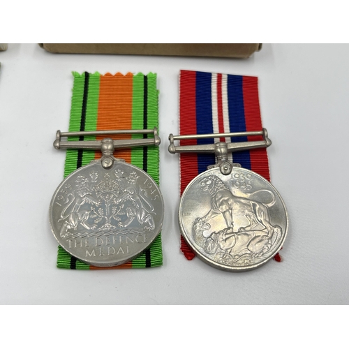 2291 - Four WWII medals, two Defence and two War with two boxes and documents