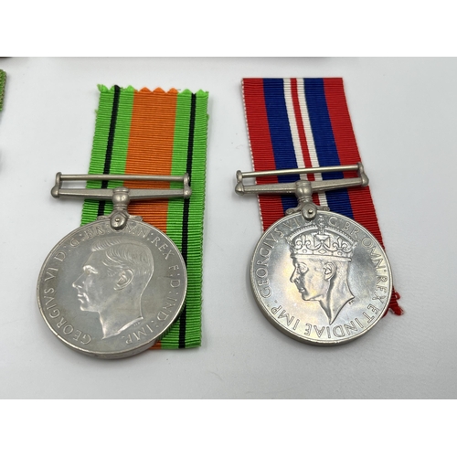 2291 - Four WWII medals, two Defence and two War with two boxes and documents