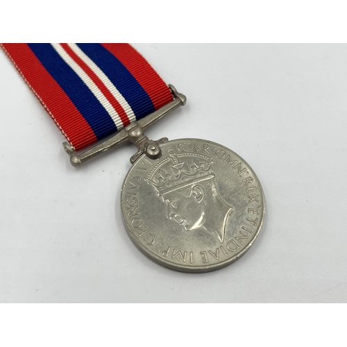 2306 - A WWII War medal with box issued to R.T. Dale. ESQ. 23 Woodside Avenue, Alsager, Stoke-On-Trent