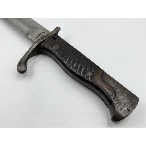 2312 - An original WWI German butcher's bayonet made by V.C. Schilling - approx. 50cm long including handle