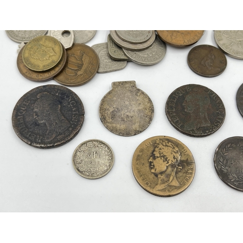 2343 - A collection of coins to include 83.5% silver 1963 Switzerland ½ franc, 64% silver 1935 and 1939 Net... 