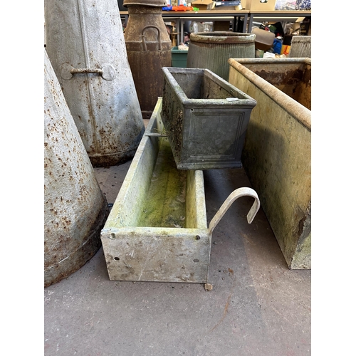 955 - Two items, one galvanised trough and one fibreglass planter - trough approx. 18cm high x 123cm long ... 