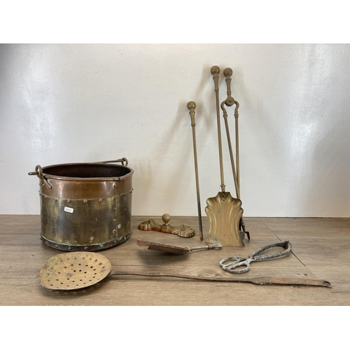 447 - A collection of antique metalware to include copper and brass riveted coal bucket, brass three piece... 