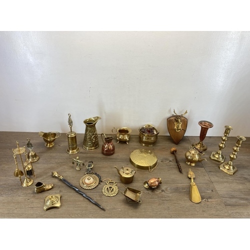 459 - A collection of copper and brassware to include novelty miniature companion set, brass jugs, miniatu... 