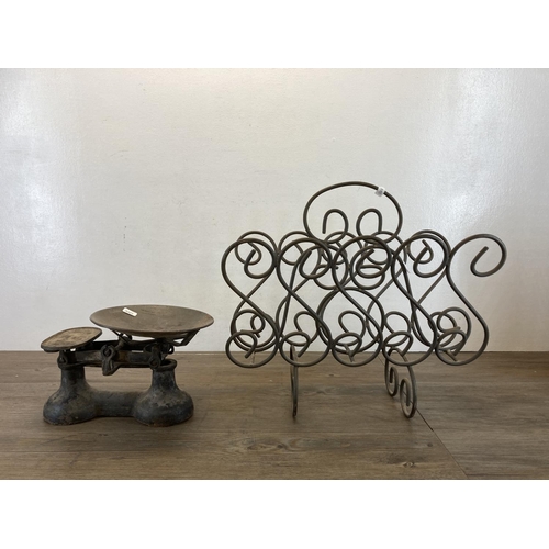 463 - Two pieces of metalware, one wrought iron two section magazine rack and a pair of 19th century cast ... 