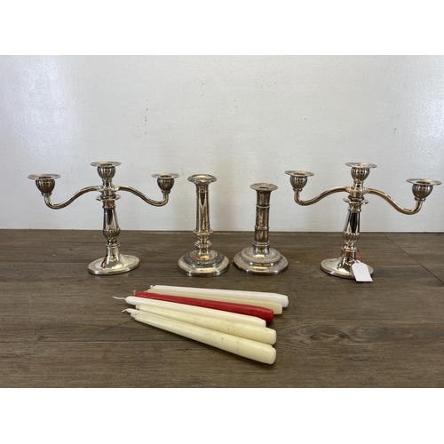 466 - Four 19th century style EPNS candlesticks, two three branch candelabras and two adjustable