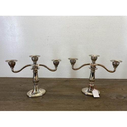 466 - Four 19th century style EPNS candlesticks, two three branch candelabras and two adjustable