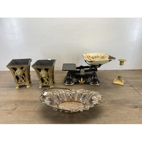 476 - Five items, one pair of gilt metal planters with lions head handles, one brass and glass candlestick... 