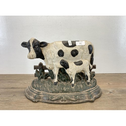 451 - A hand painted cast iron cow doorstop