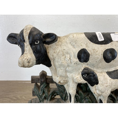 451 - A hand painted cast iron cow doorstop