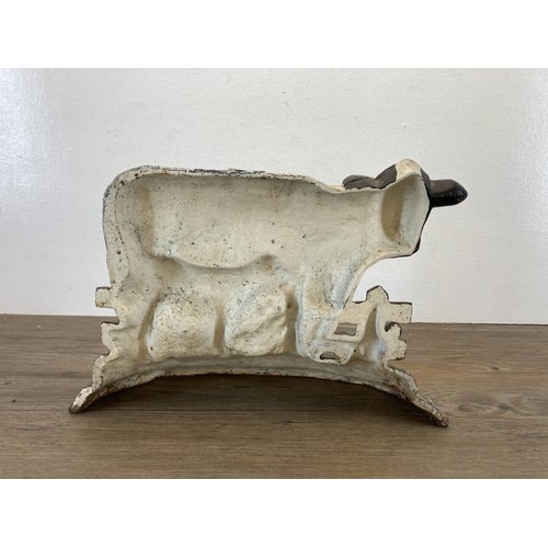 451 - A hand painted cast iron cow doorstop