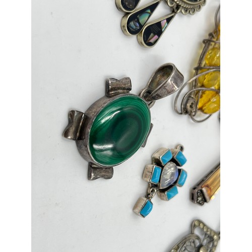 2101 - A collection of .925 silver gemstone set pendants to include malachite, abalone shell etc.