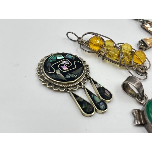 2101 - A collection of .925 silver gemstone set pendants to include malachite, abalone shell etc.