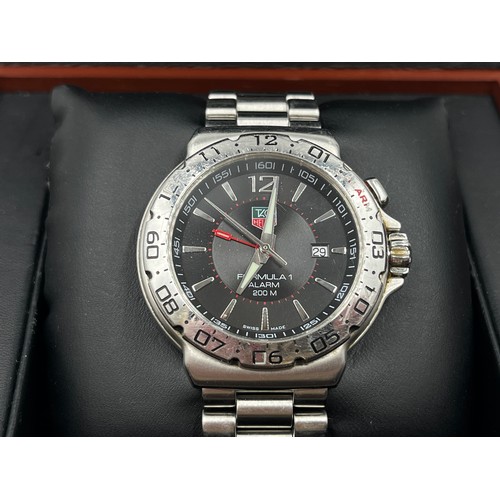 A boxed Tag Heuer Formula 1 WAC111A alarm quartz wristwatch with stainless steel bracelet and double lock clasp, original purchase receipt, guarantee card and spare links