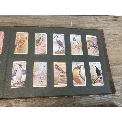 573 - Three vintage cigarette card albums containing a large collection of cigarette cards to include Will... 