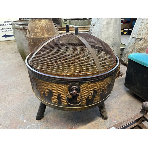 960 - Two items, one cast iron fire grate with griddle and one tri- footed garden fire pit