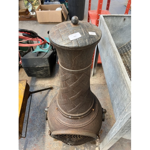 965 - A cast iron chiminea - approx. 110cm high