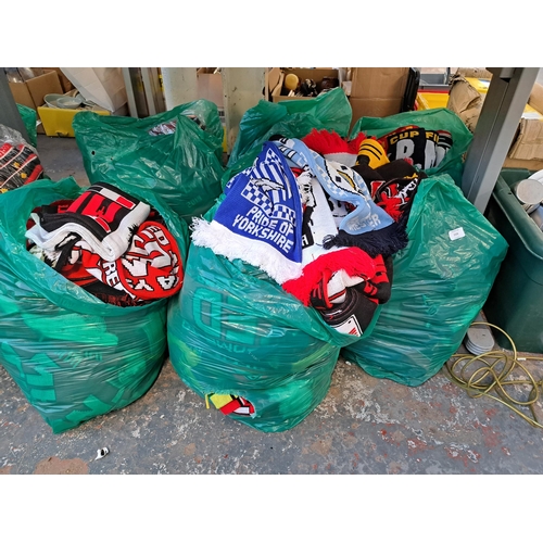 1026 - Nine bags containing a large collection of football scarves to include Manchester United, Manchester... 