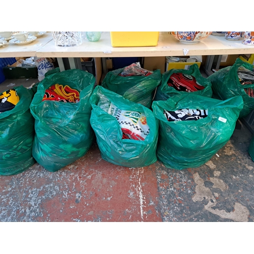 1027 - Nine bags containing a large collection of football scarves to include Manchester United, Manchester... 