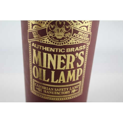 594 - Two brass miner's lamps to include boxed E. Thomas & Williams Ltd etc.