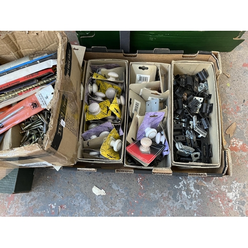 1037 - Seven boxes containing a large collection of door handles and knobs, drill bits, hinges, screws etc.