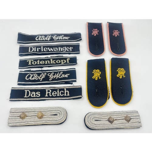 2309 - A collection of reproduction German military shoulder boards and cuff titles