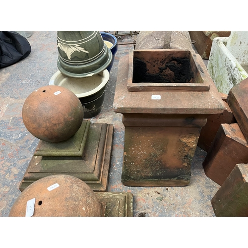 937 - Three terracotta garden items, one Victorian chimney pot and one pair of ball pillar caps