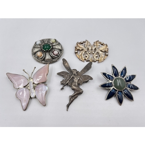 2086 - Five white metal brooches to include Celtic design, enamel etc.