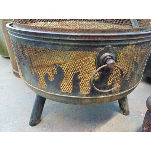 960 - Two items, one cast iron fire grate with griddle and one tri- footed garden fire pit