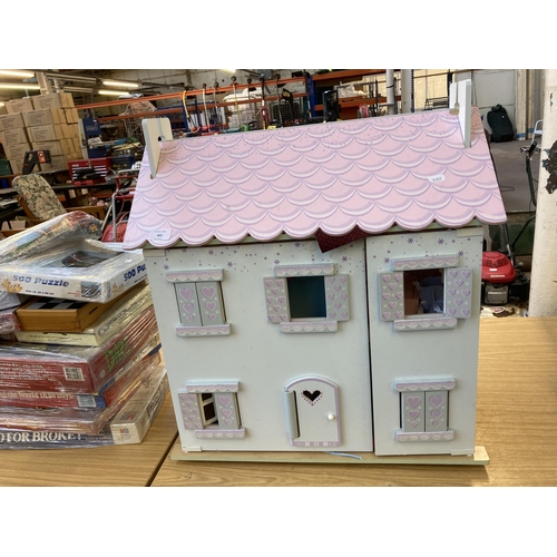 589 - A three storey dolls house - approx. 68cm high x 61cm wide x 35cm deep