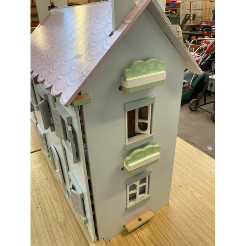 589 - A three storey dolls house - approx. 68cm high x 61cm wide x 35cm deep