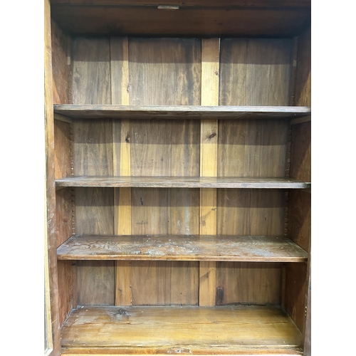 16 - A Victorian satinwood bookcase with two upper glazed doors and two lower cupboard doors - approx. 22... 