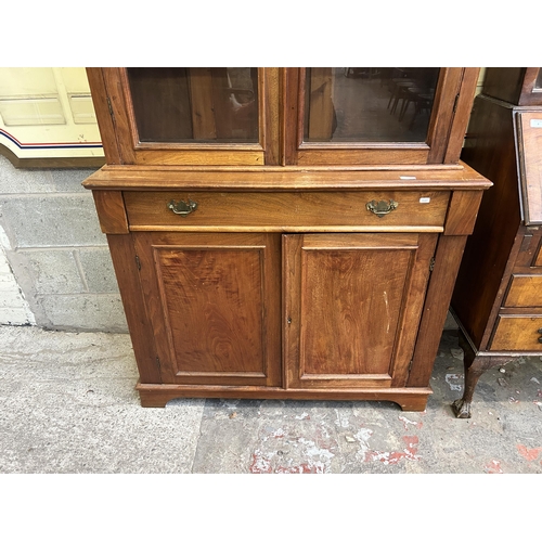 16 - A Victorian satinwood bookcase with two upper glazed doors and two lower cupboard doors - approx. 22... 