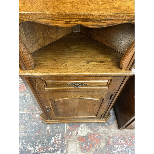 191 - An oak free standing corner cabinet