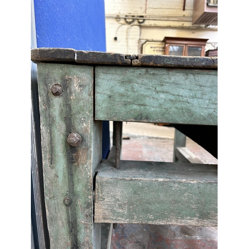 193 - An early 20th century green painted pine work bench - approx. 85cm high x 79cm wide x 170cm long