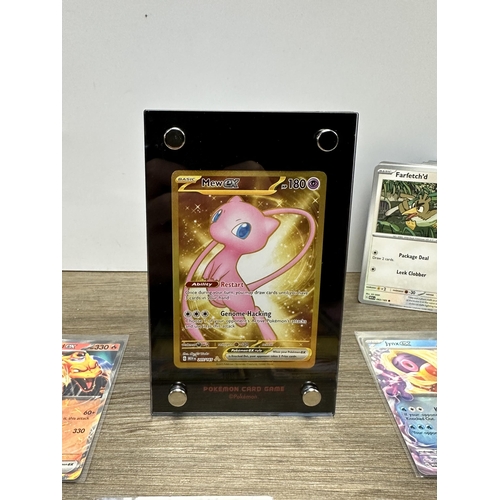 598 - A collection of Pokémon trading cards together with a Game Freak Pokémon themed gaming mat