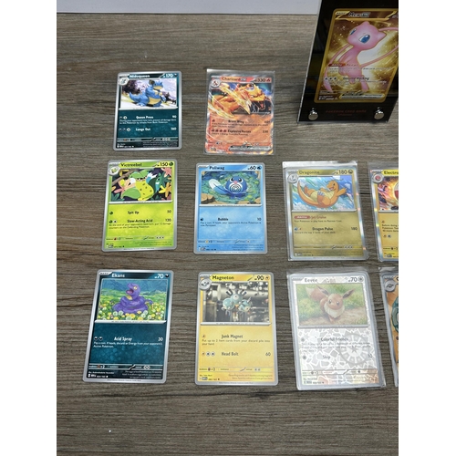 598 - A collection of Pokémon trading cards together with a Game Freak Pokémon themed gaming mat