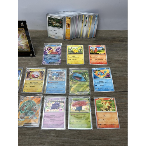 598 - A collection of Pokémon trading cards together with a Game Freak Pokémon themed gaming mat