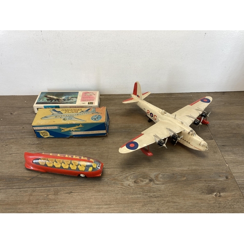 580 - Four vintage model vehicles to include boxed friction drive tin plate passenger plane, tin plate pas... 