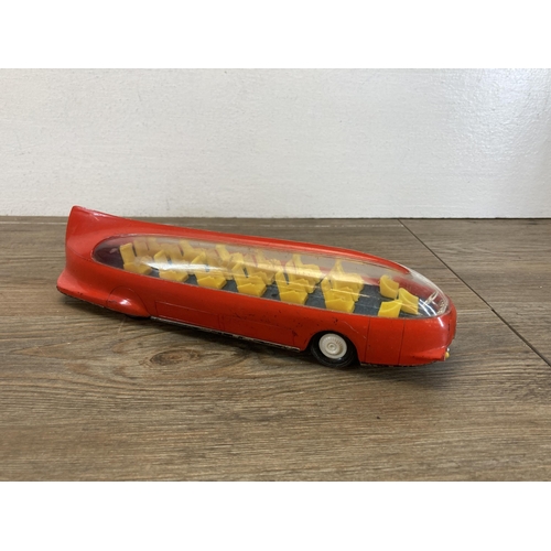 580 - Four vintage model vehicles to include boxed friction drive tin plate passenger plane, tin plate pas... 