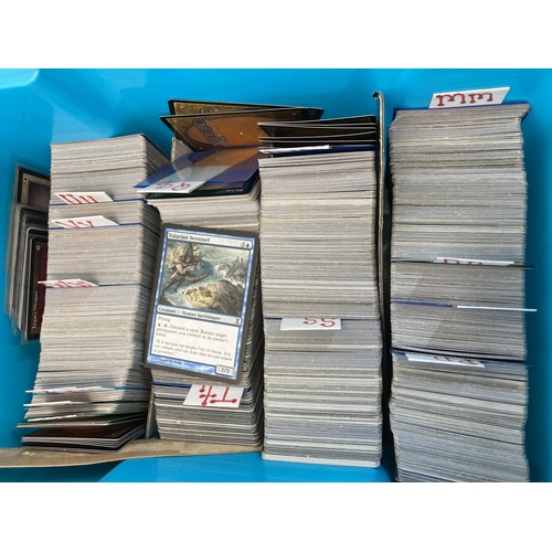 584 - Three boxes containing a large collection of Magic The Gathering trading cards