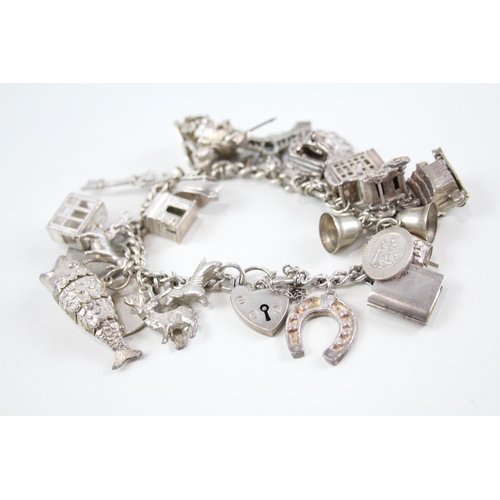 2061 - A silver charm bracelet with assorted charms - approx. gross weight 82g