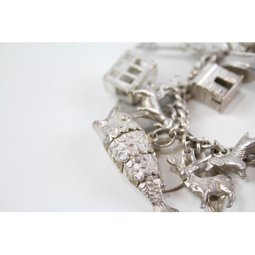 2061 - A silver charm bracelet with assorted charms - approx. gross weight 82g